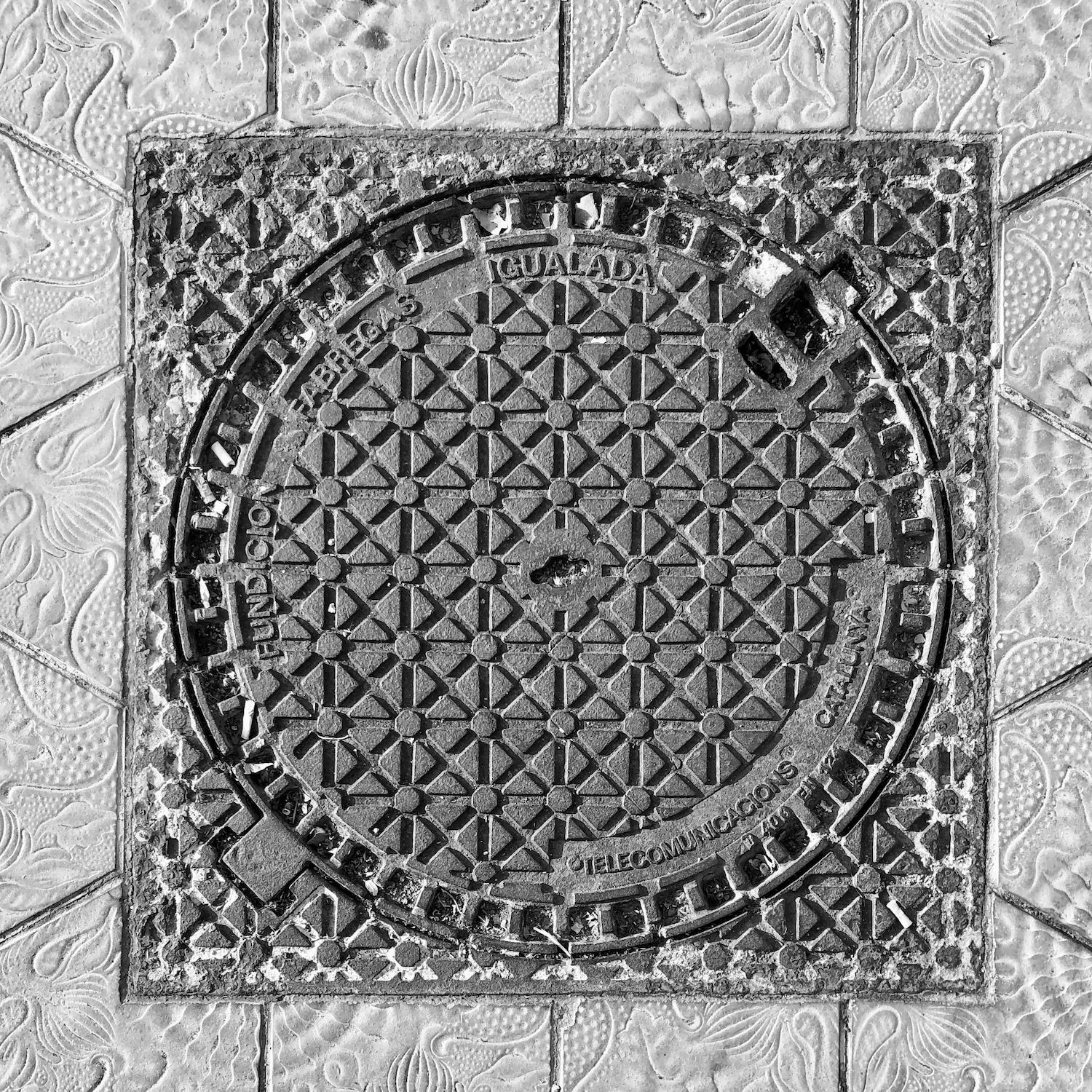 black and white image of a utility cover