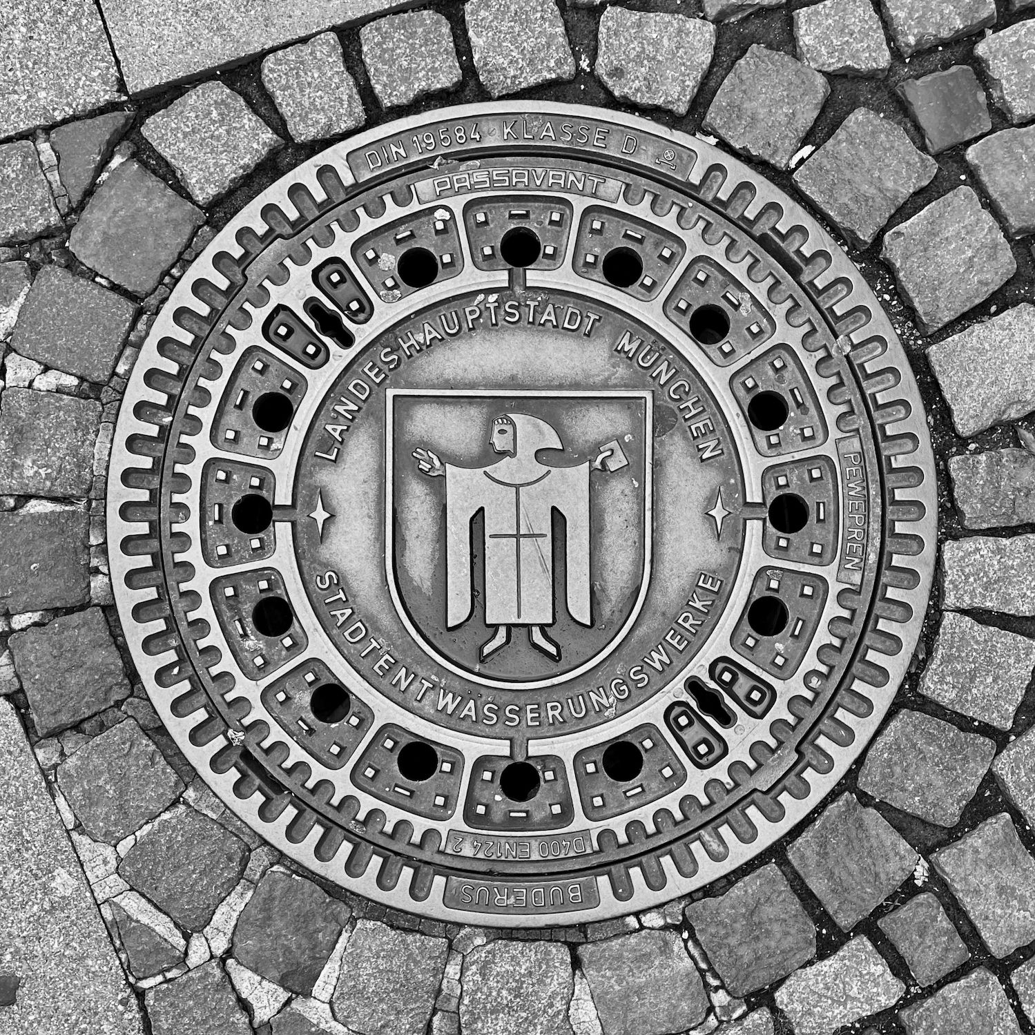 black and white image of a utility cover