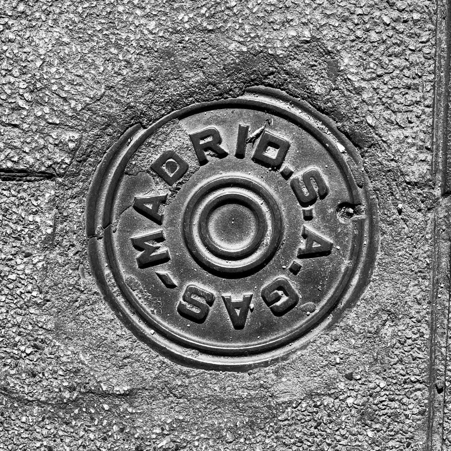 black and white image of a utility cover