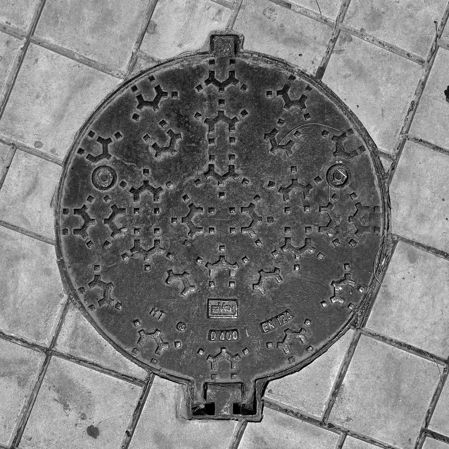 black and white image of a utility cover