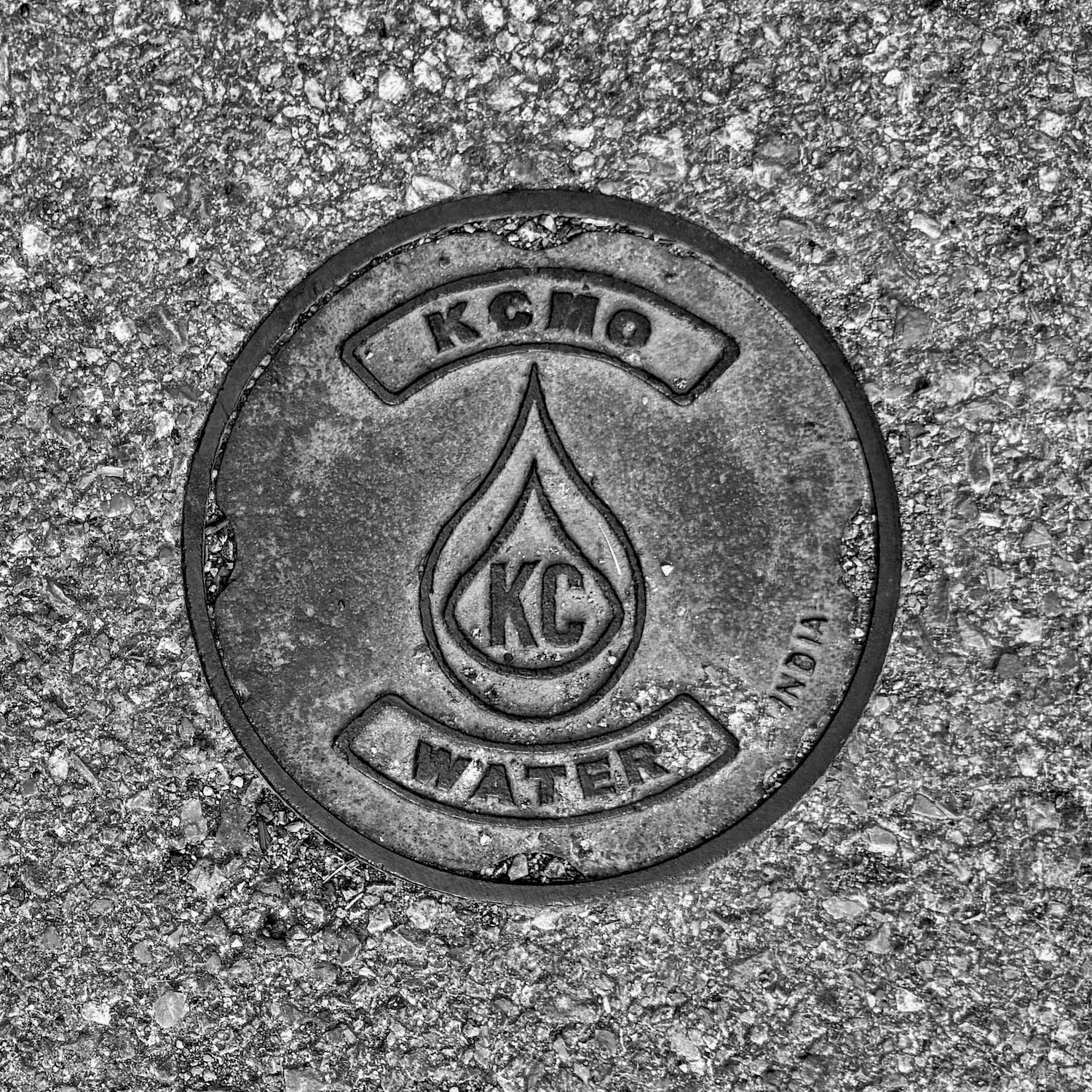 black and white image of a utility cover
