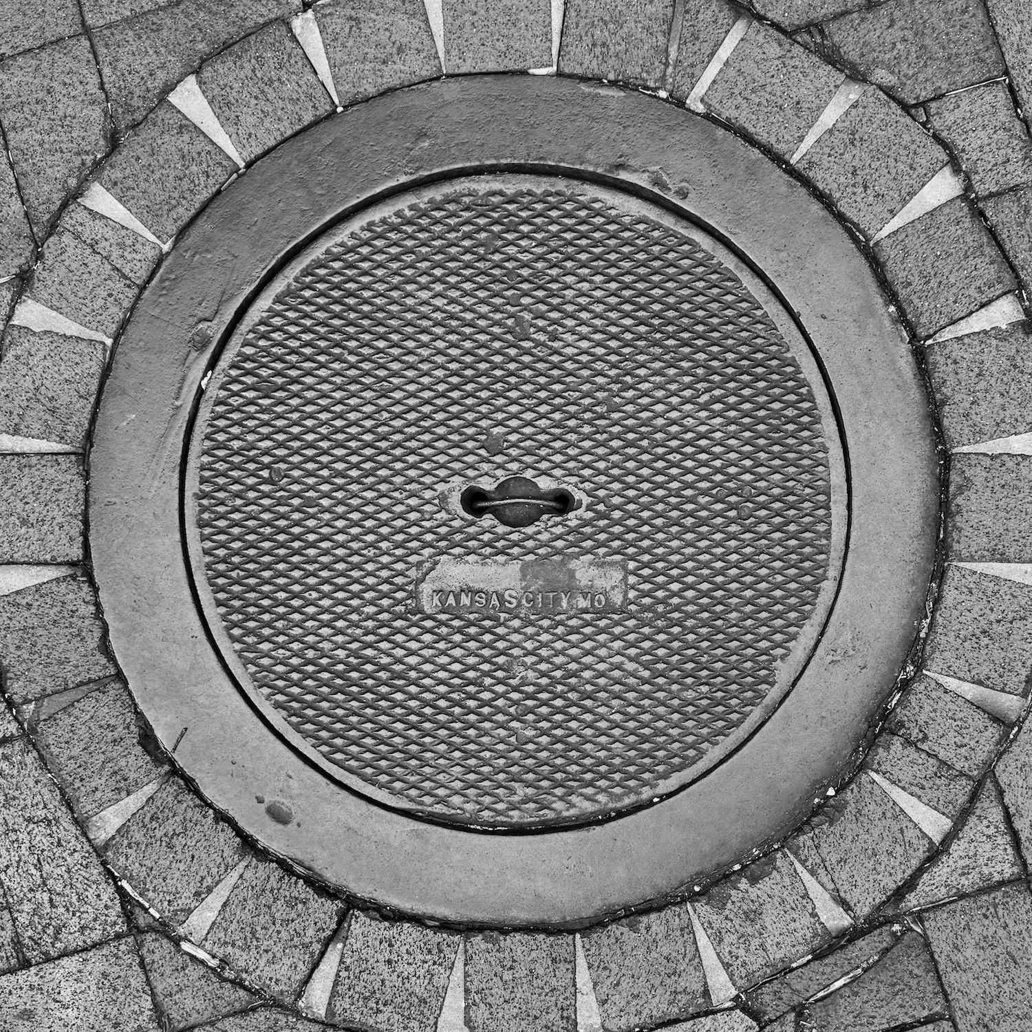 black and white image of a utility cover