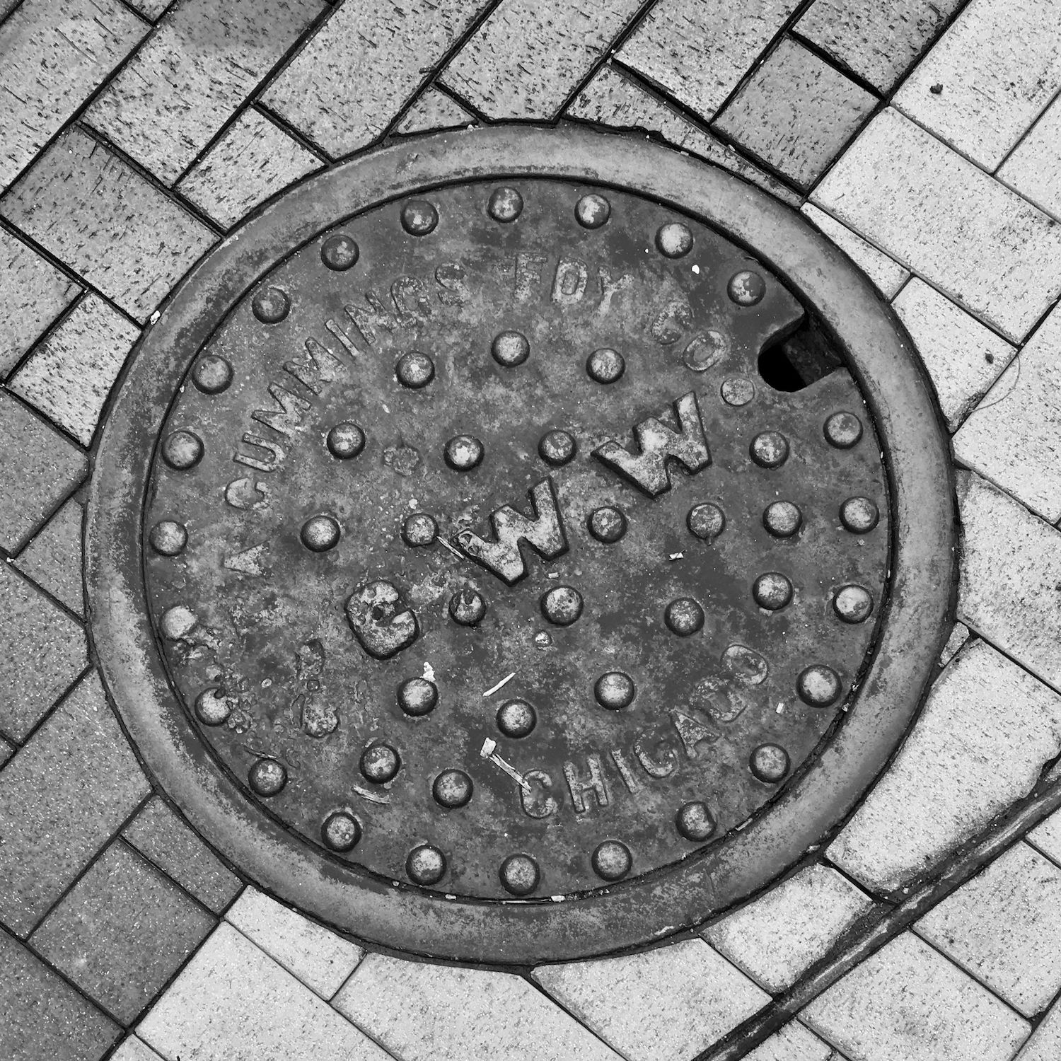black and white image of a utility cover
