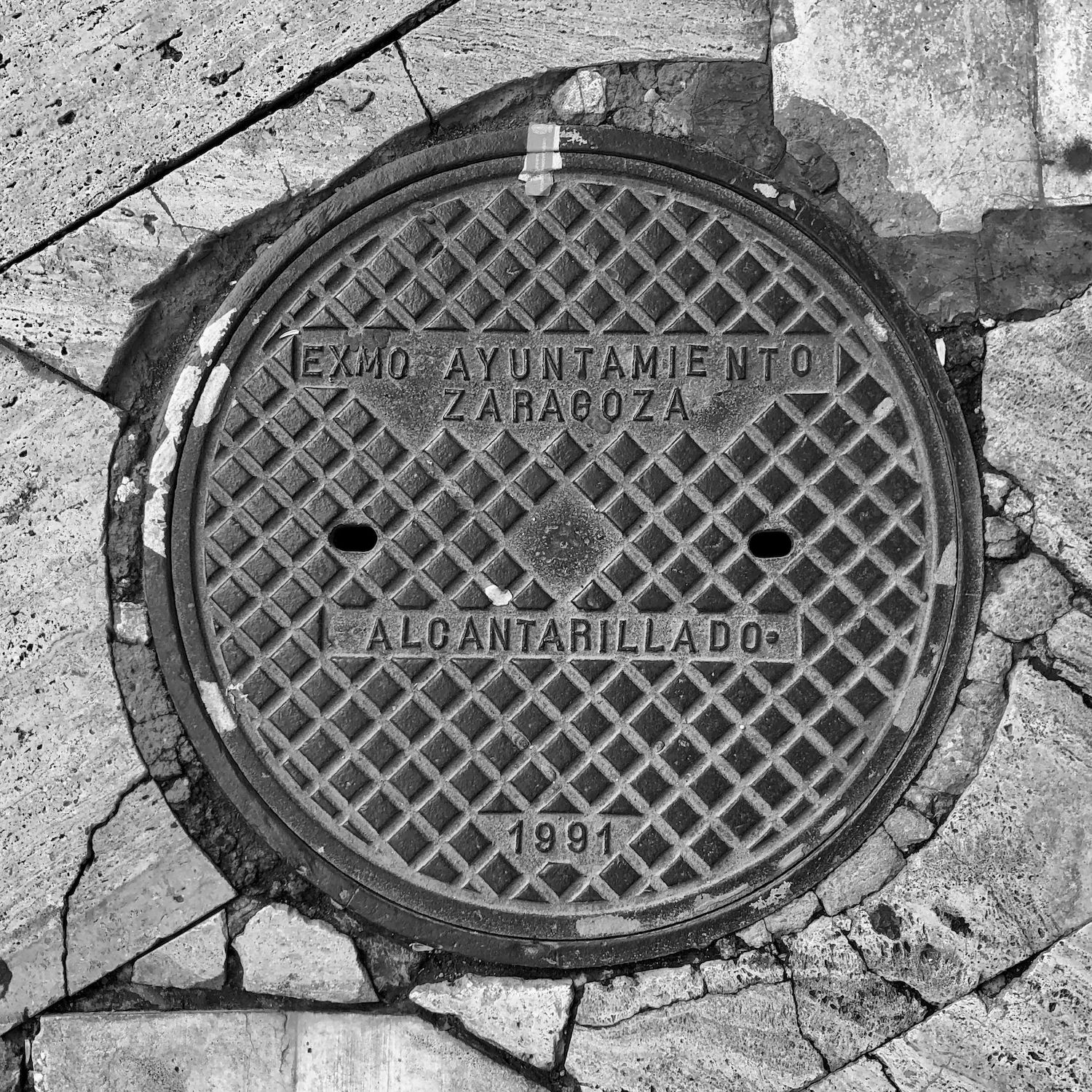 black and white image of a utility cover