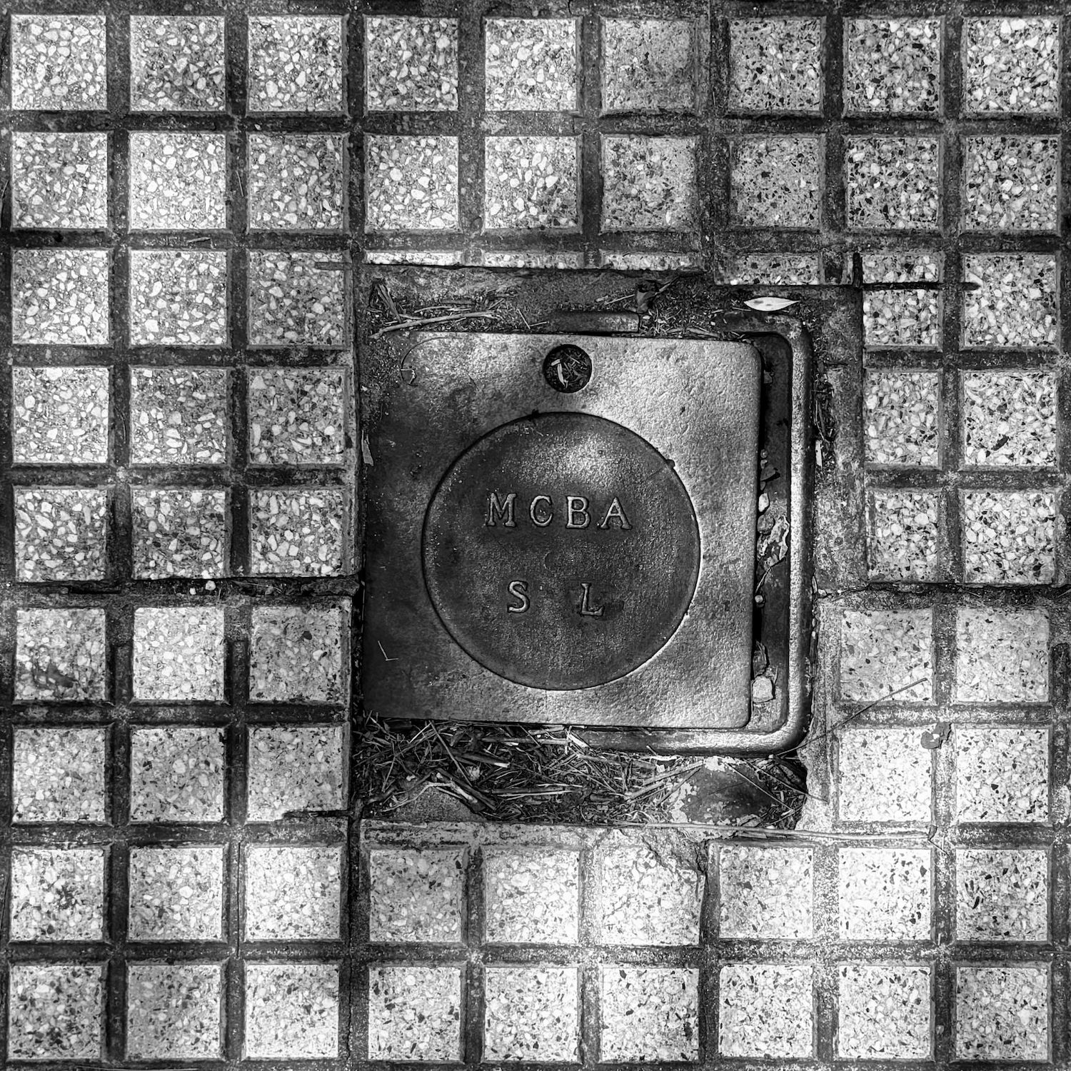 black and white image of a utility cover