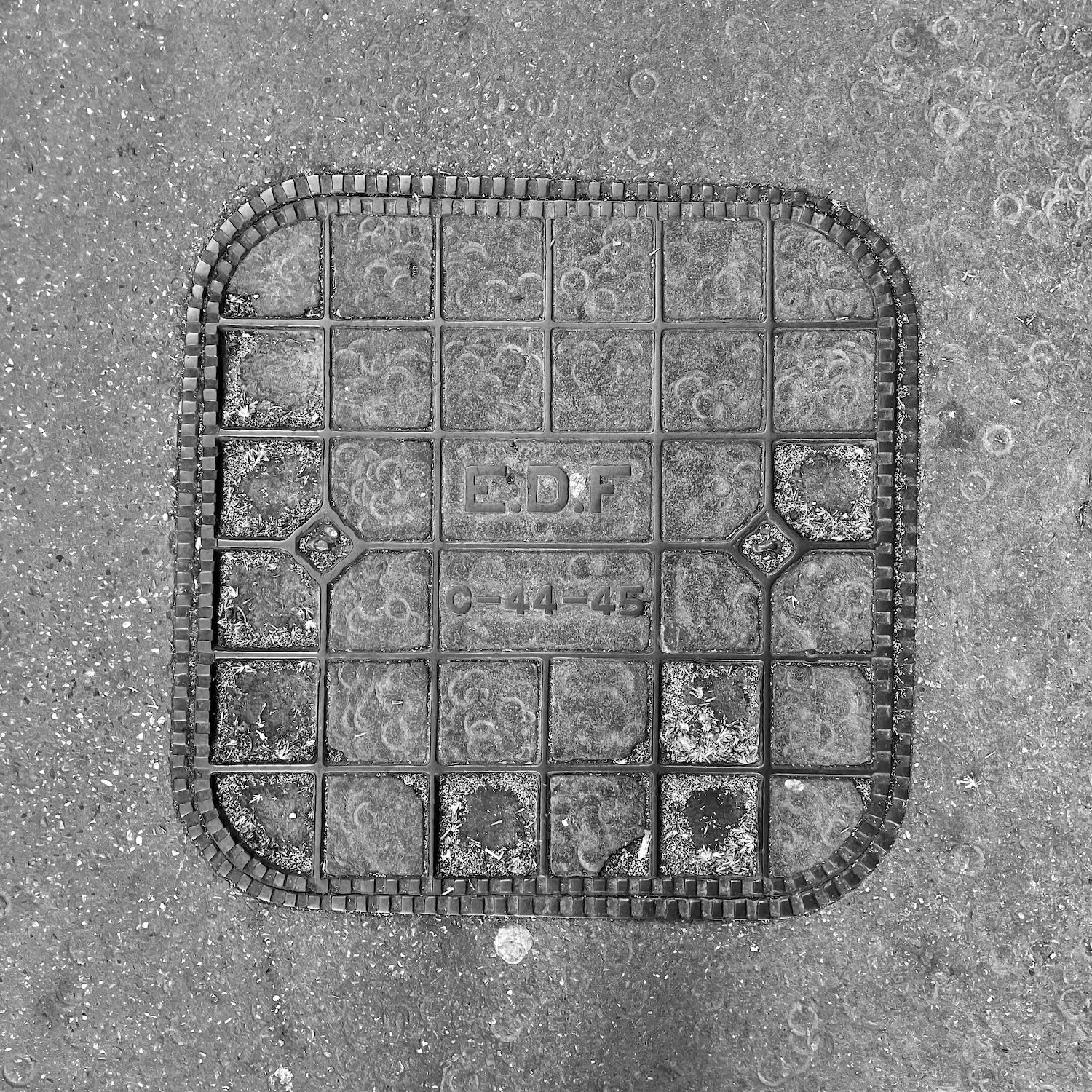 black and white image of a utility cover