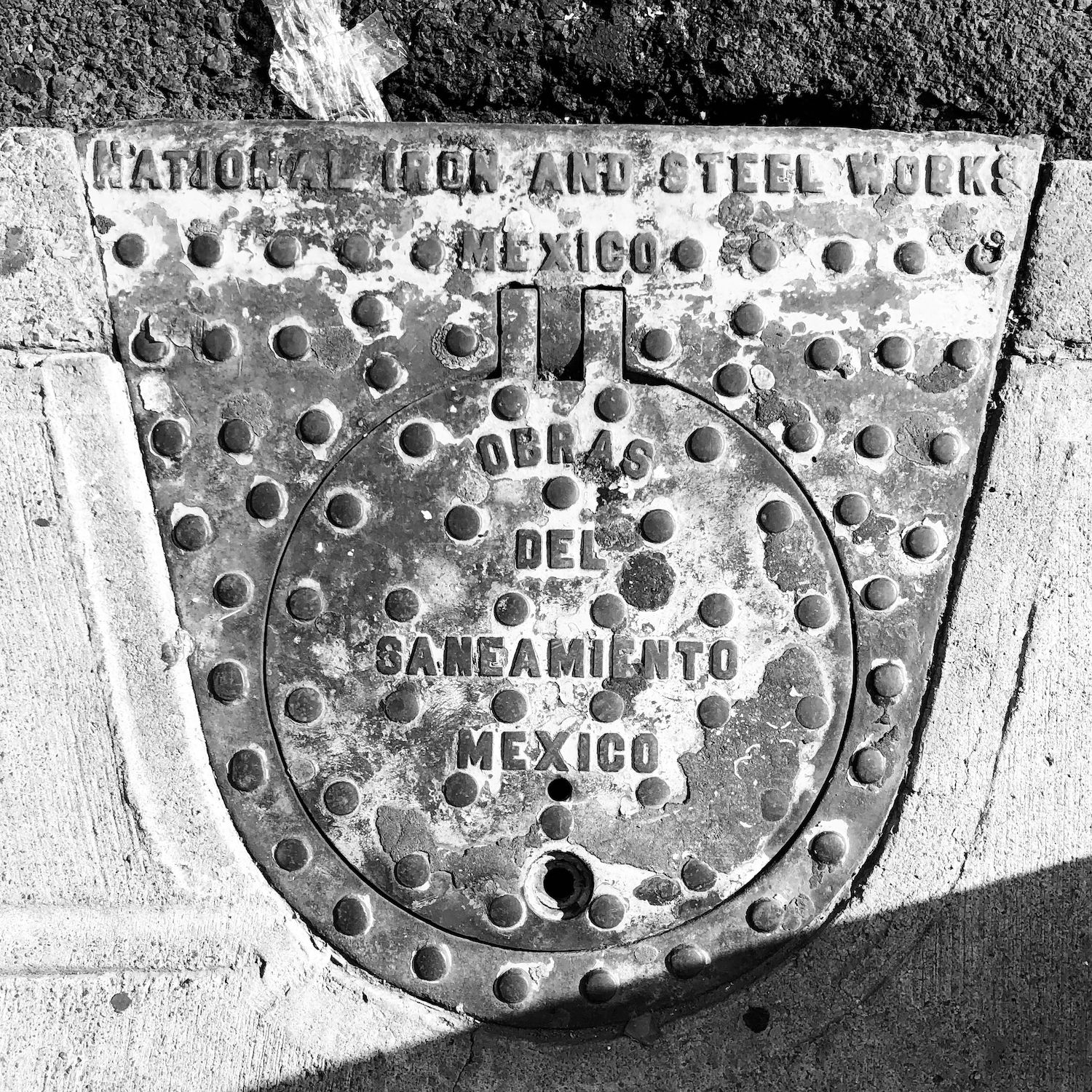 black and white image of a utility cover