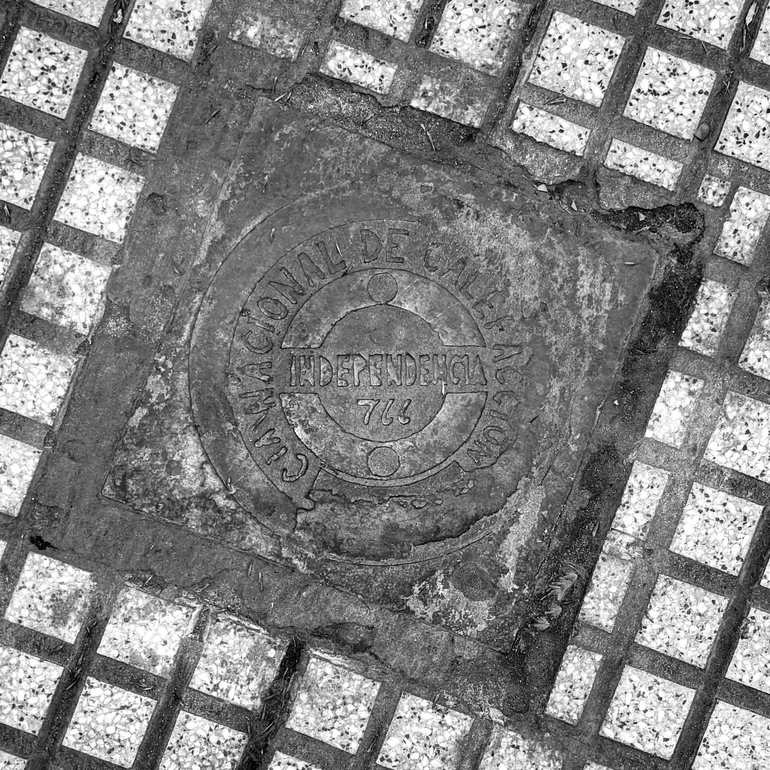 black and white image of a utility cover