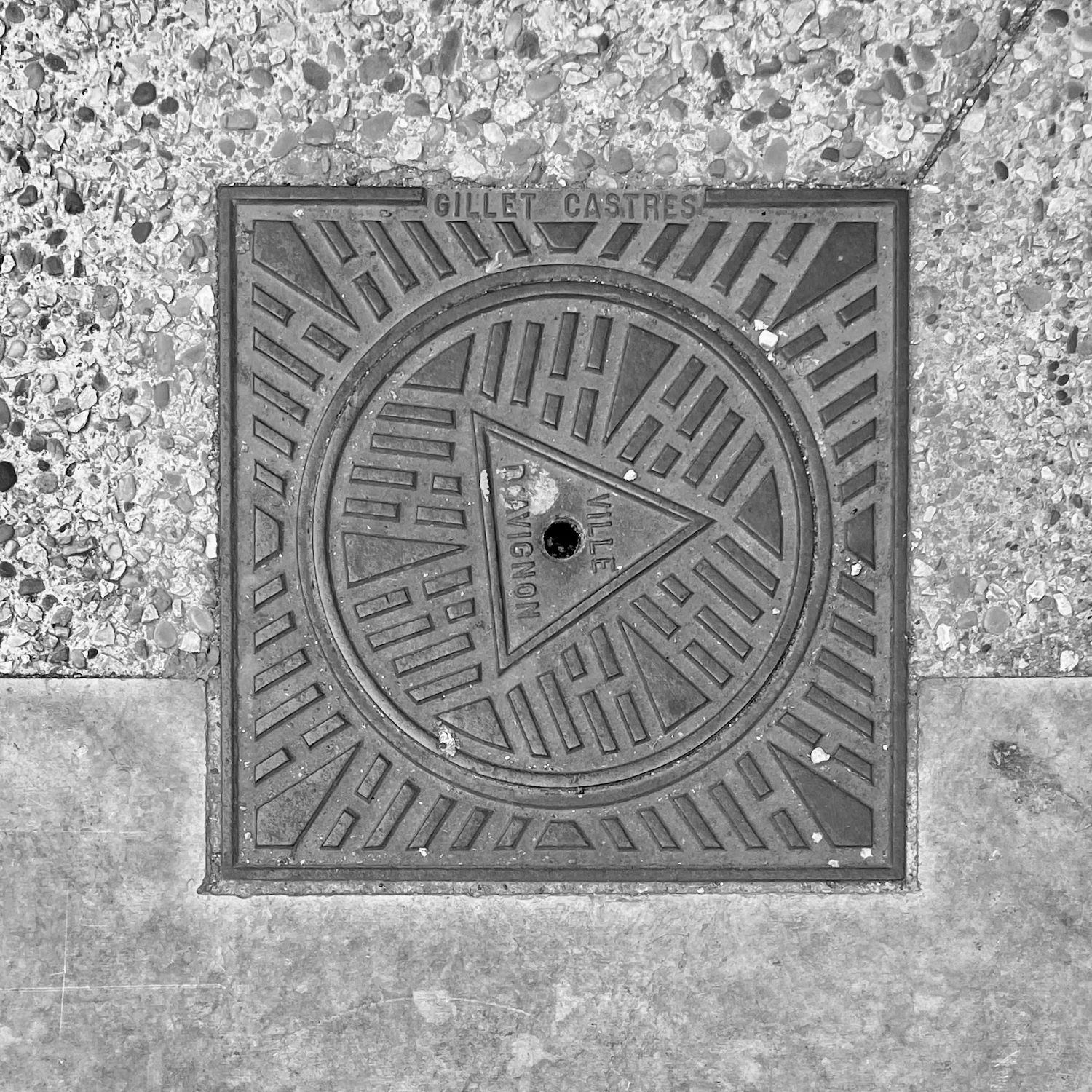 black and white image of a utility cover
