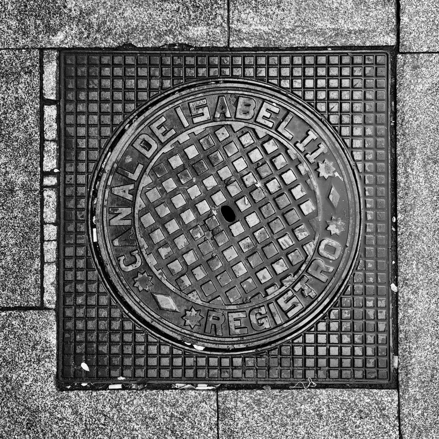 black and white image of a utility cover