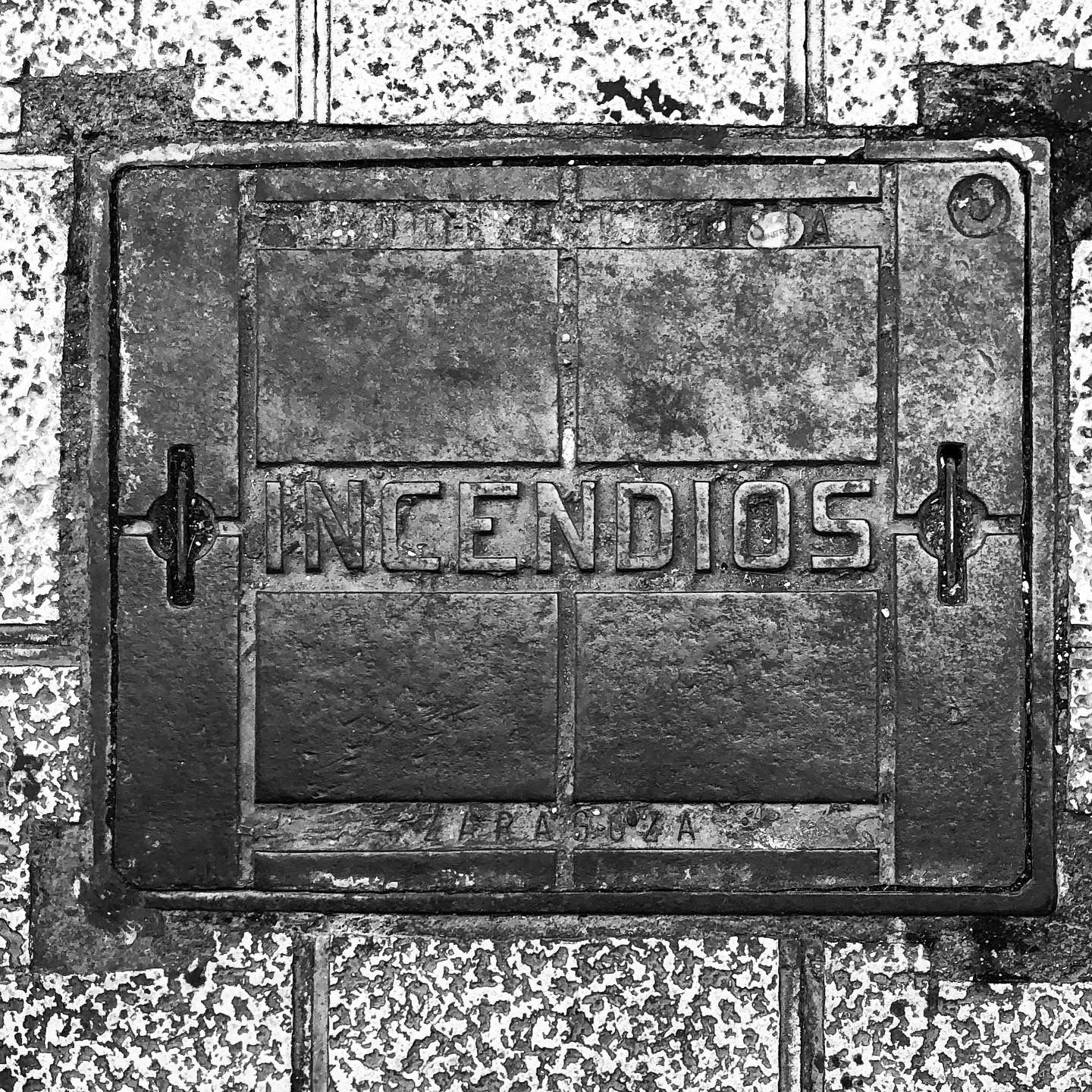 black and white image of a utility cover