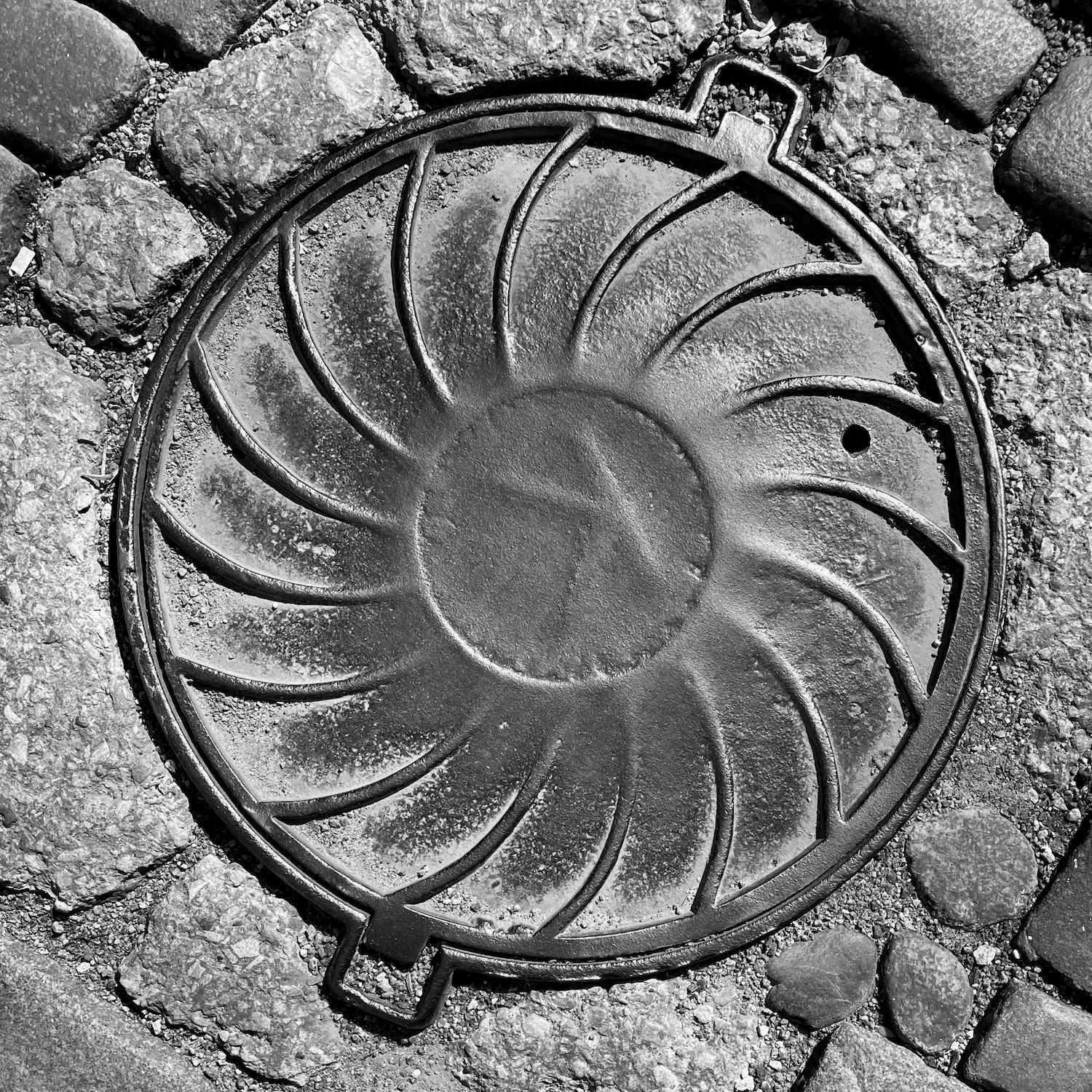 black and white image of a utility cover