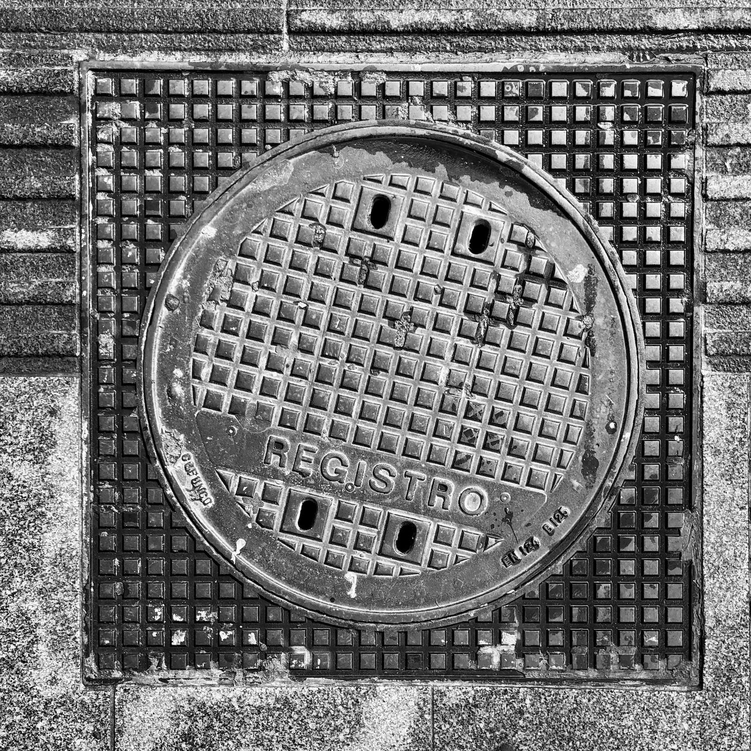 black and white image of a utility cover