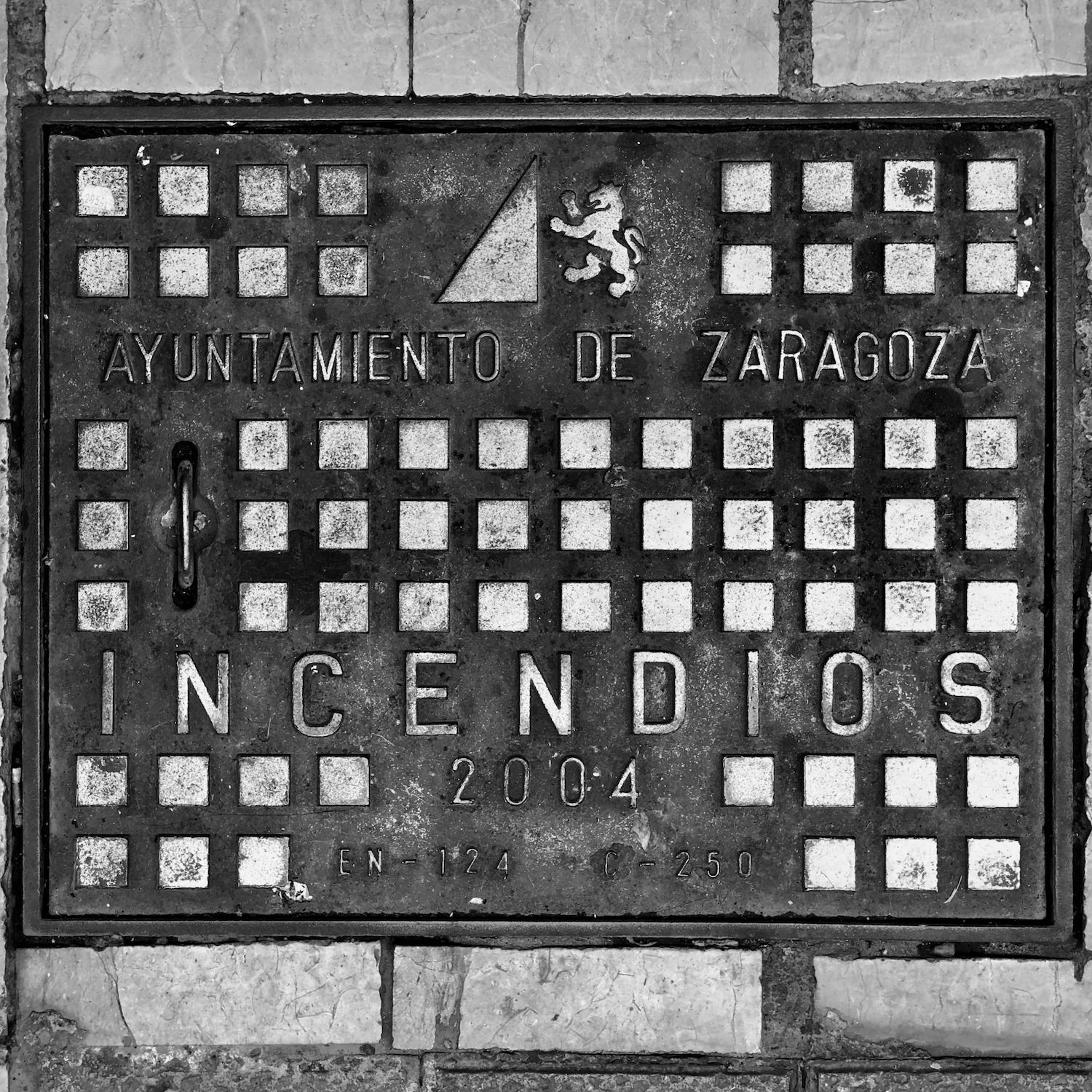 black and white image of a utility cover