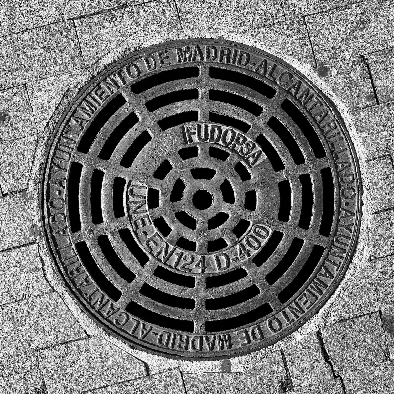 black and white image of a utility cover