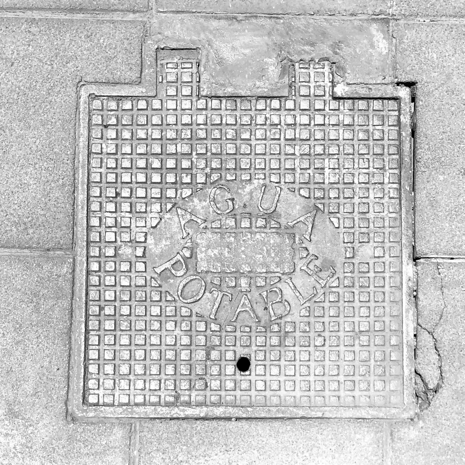 black and white image of a utility cover