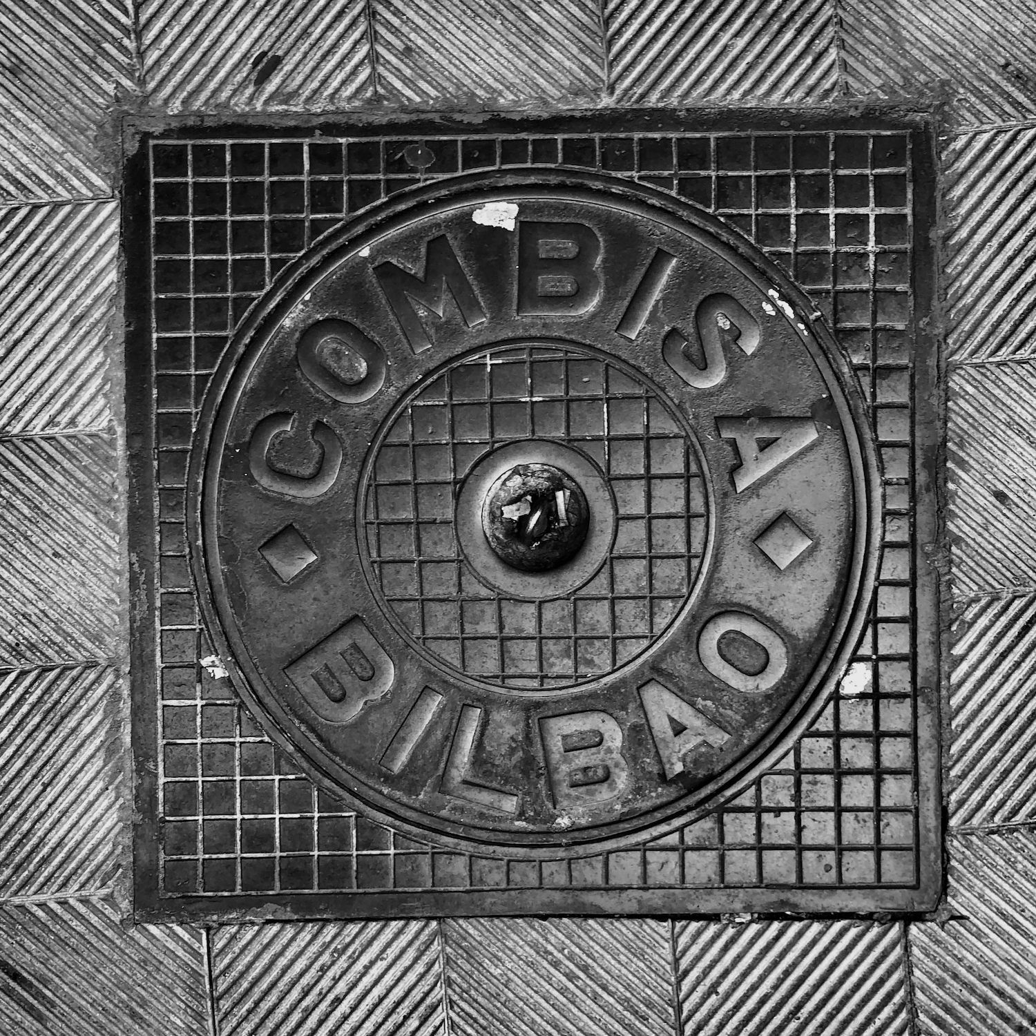 black and white image of a utility cover