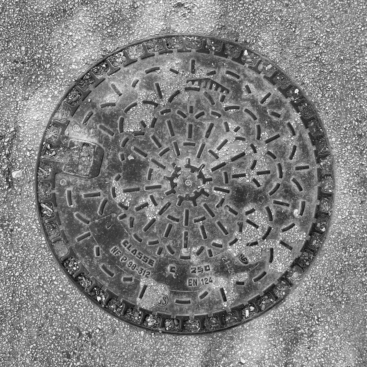 black and white image of a utility cover