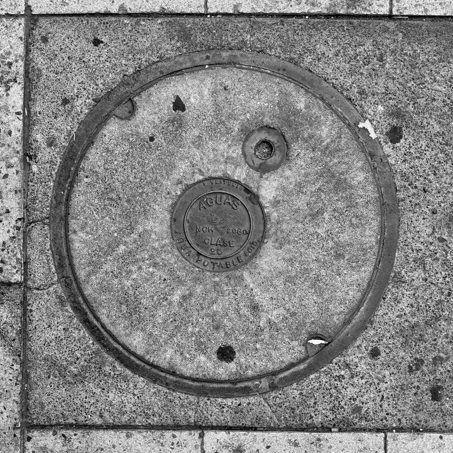 black and white image of a utility cover
