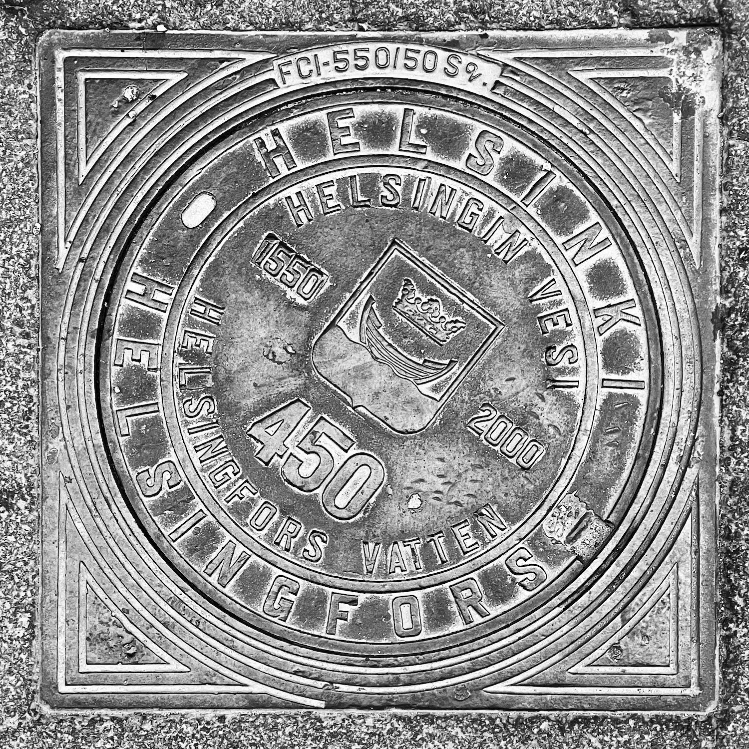 black and white image of a utility cover