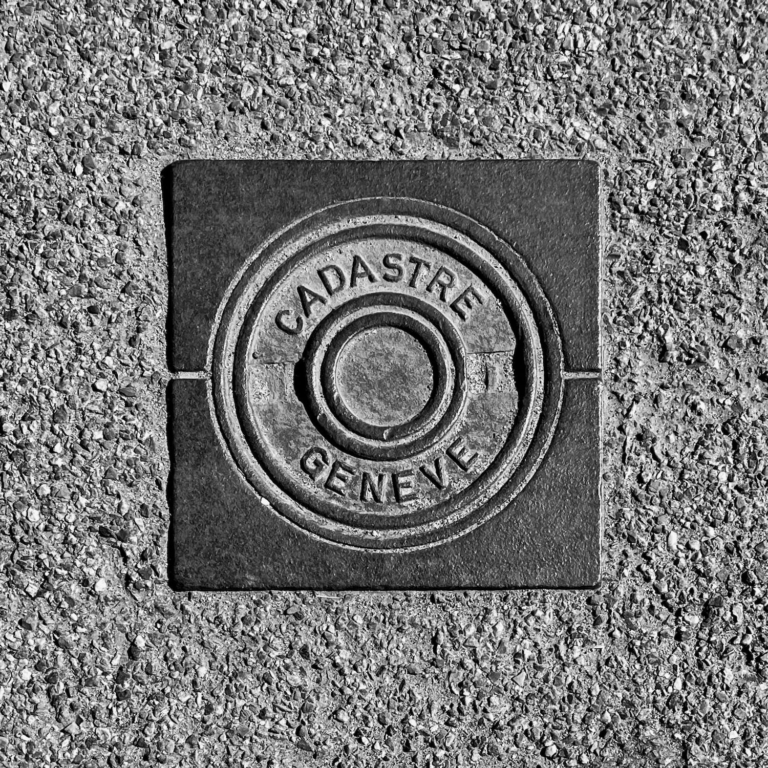 black and white image of a utility cover