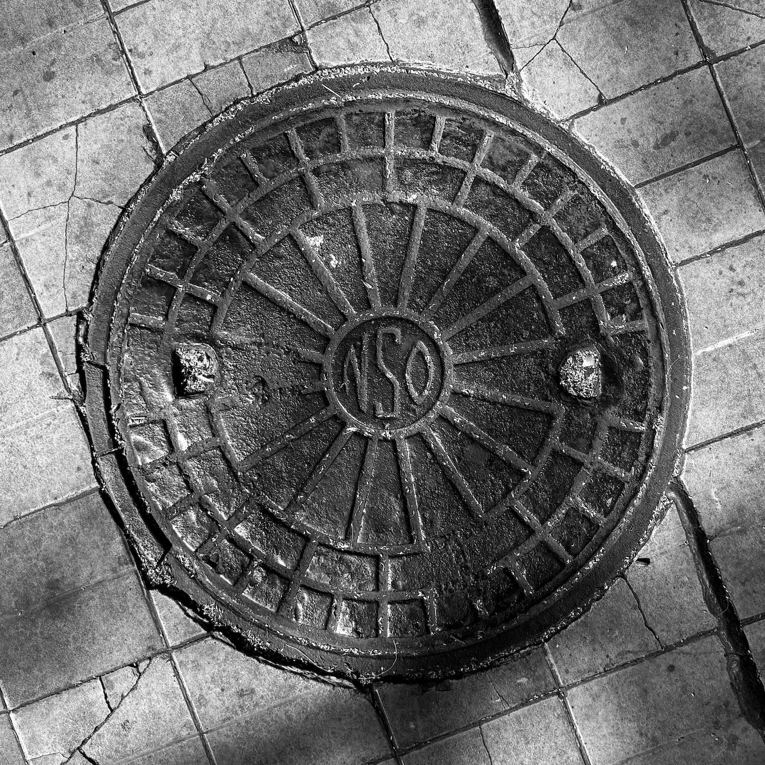 black and white image of a utility cover