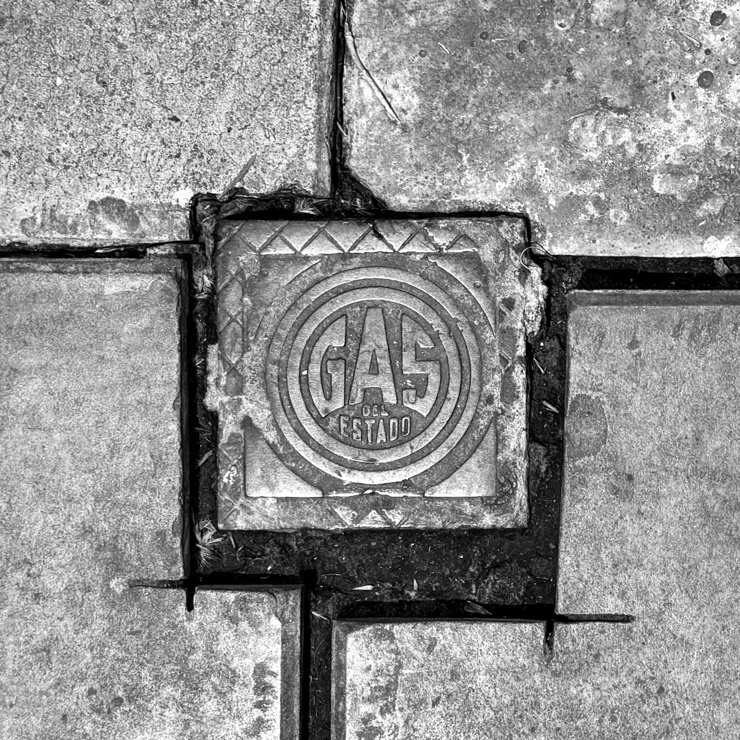 black and white image of a utility cover