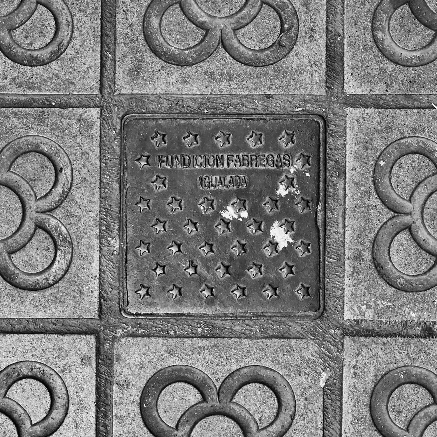 black and white image of a utility cover