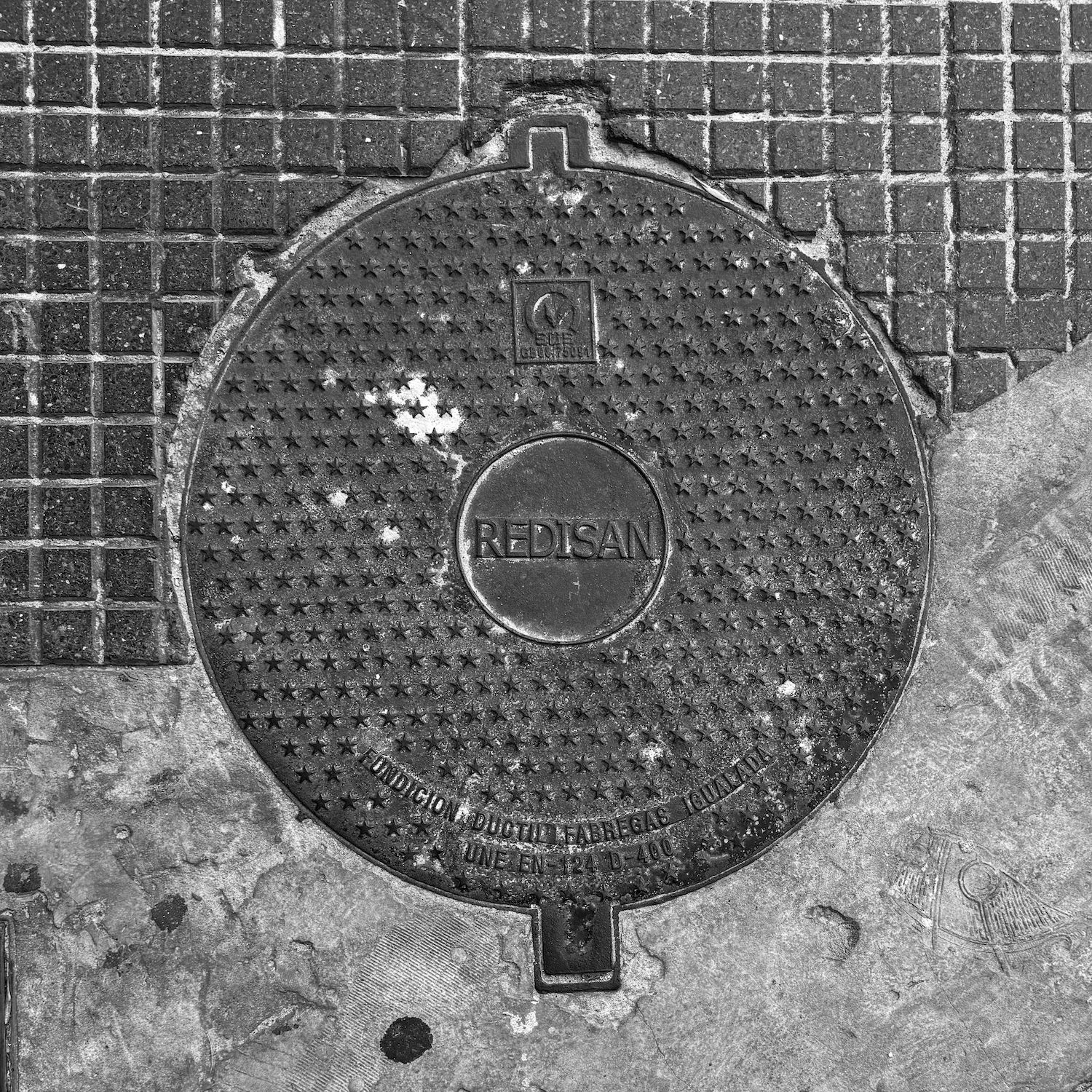 black and white image of a utility cover