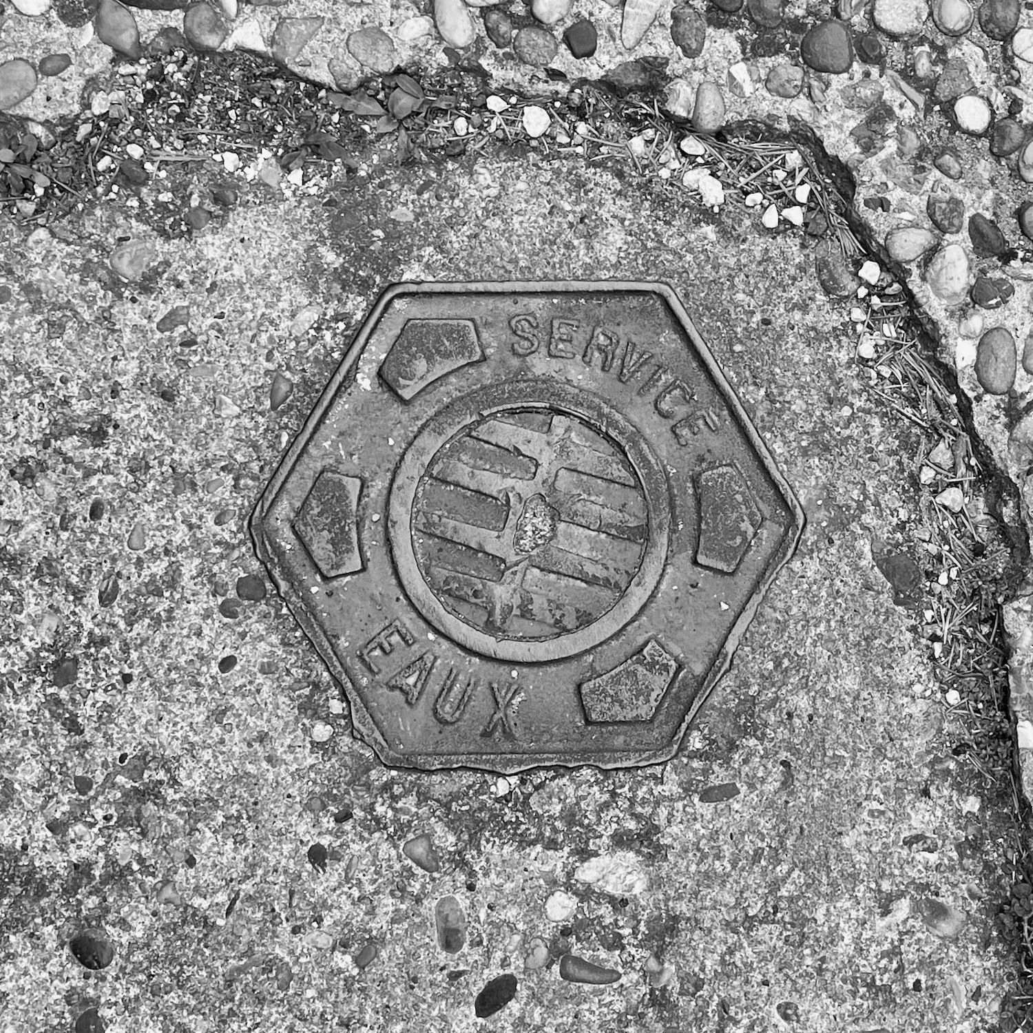 black and white image of a utility cover