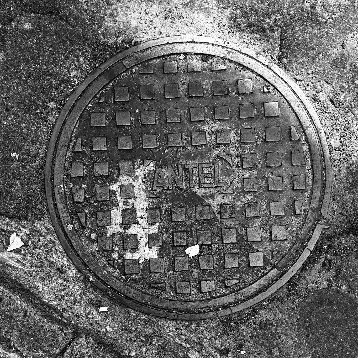 black and white image of a utility cover